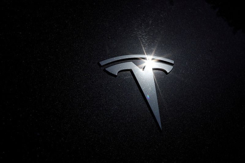 The Tesla logo is seen on a car in Los Angeles